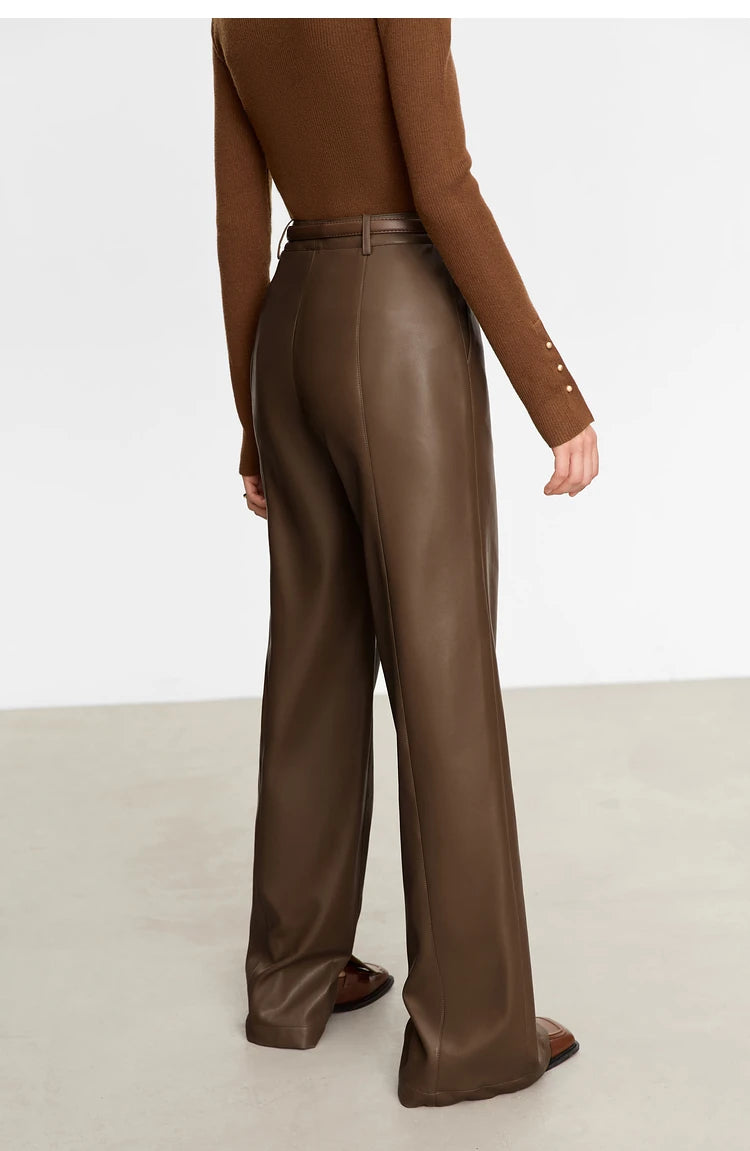 Person wearing black wide-leg pants and a white shirt on a gray background with 'Amii' branding.