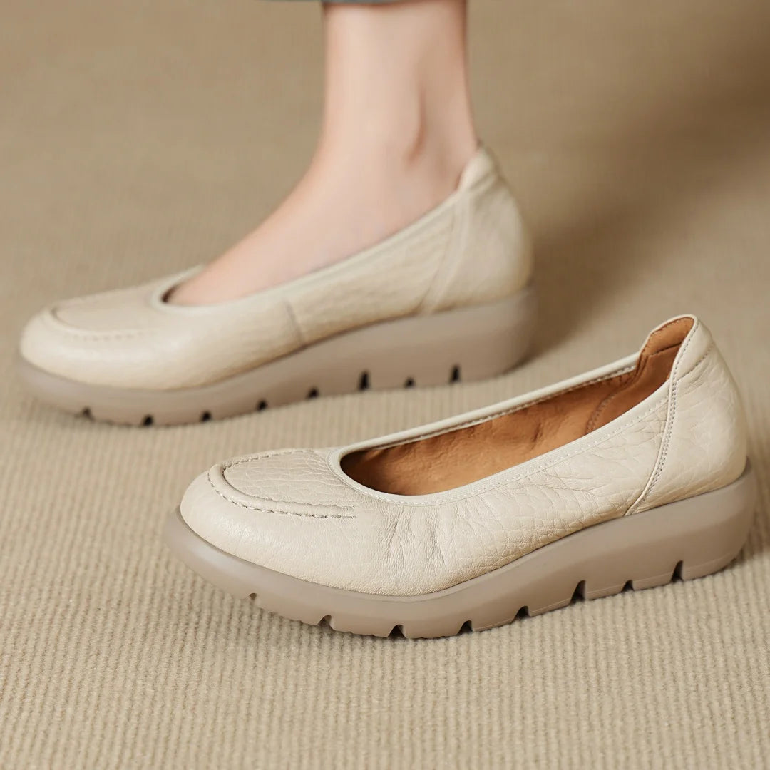 Beige loafers on a beige surface
