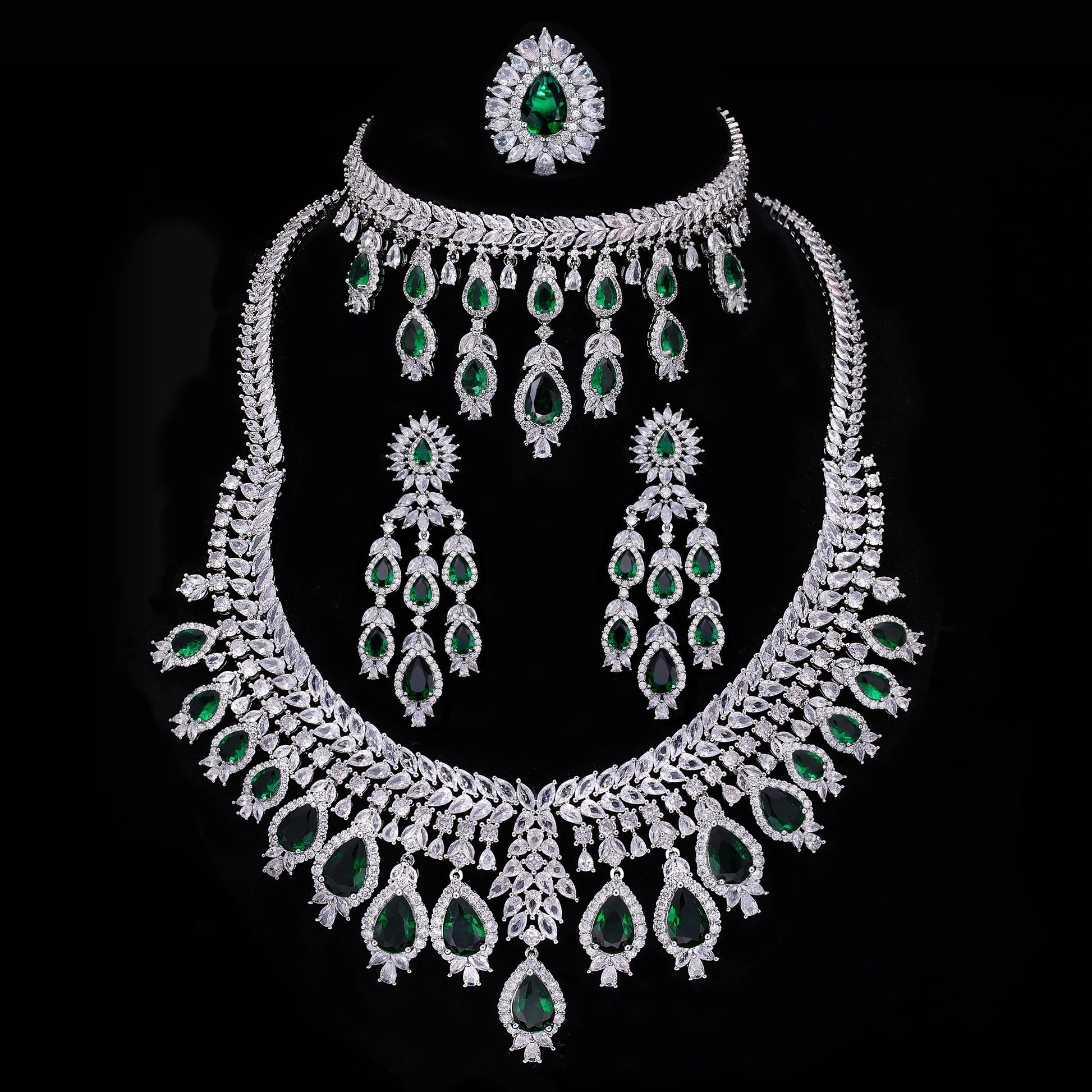 Jewelry set with necklace, earrings, and ring on a black background