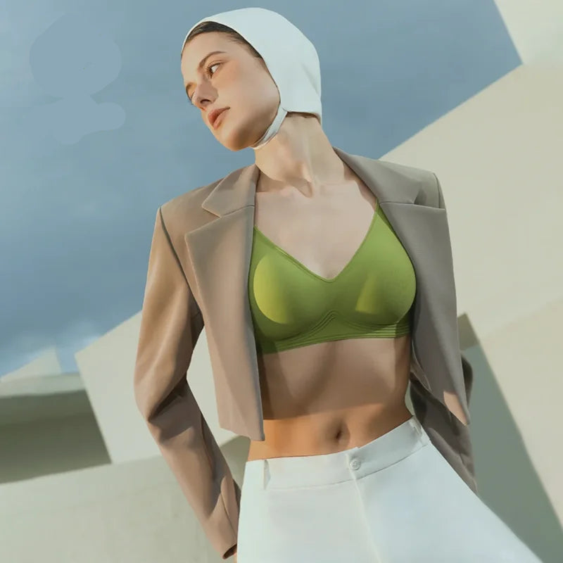 Woman wearing a green bralette and beige jacket with 'Suijin' logo in the corner.