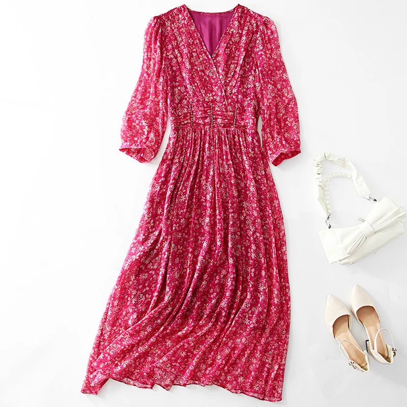 Pink floral dress with white shoes and handbag on a light gray background