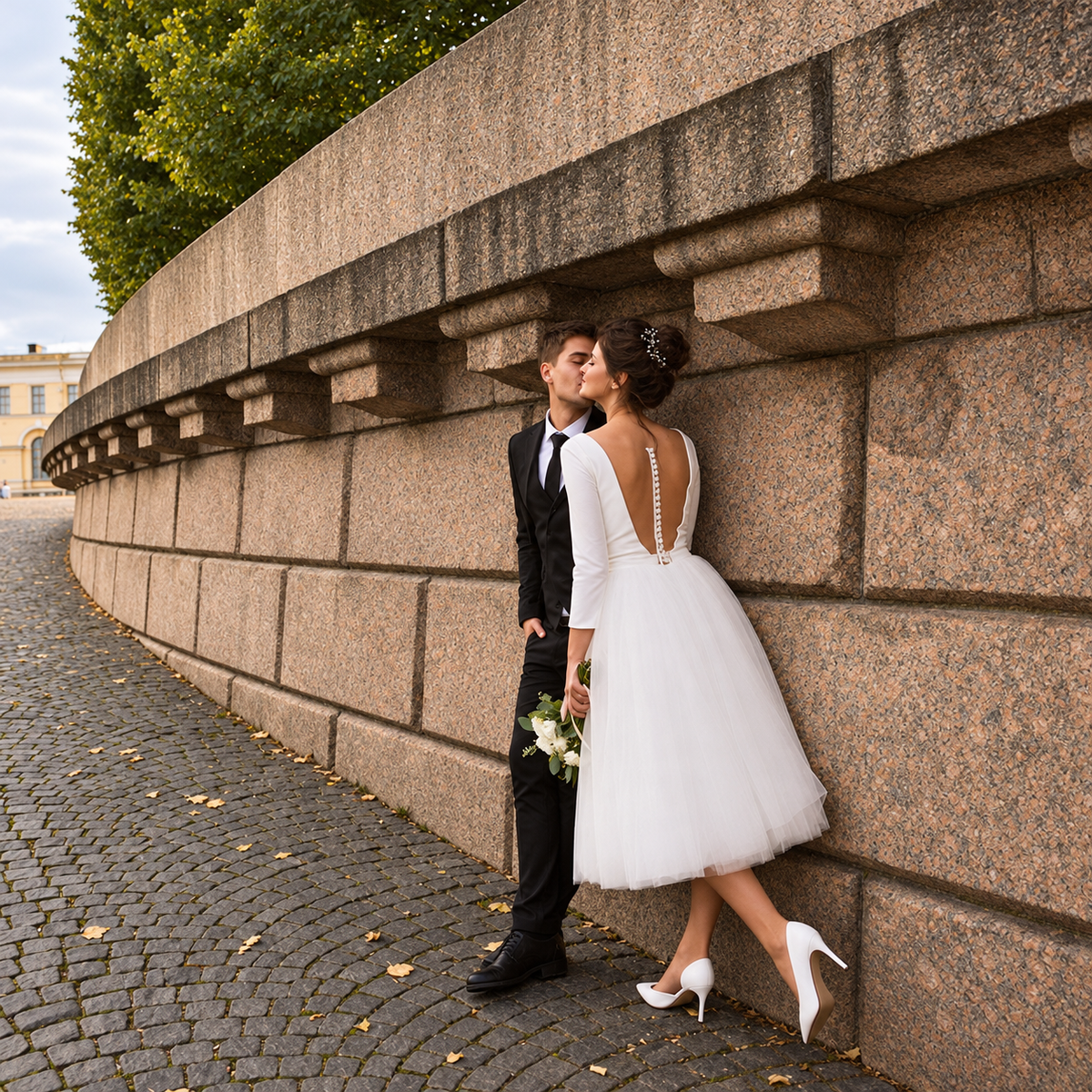 Short A-Line Wedding Dress – Tea-Length V-Neck Bridal Gown with three-quarter sleeves and flowing tulle skirt, styled for a romantic outdoor wedding portrait. 