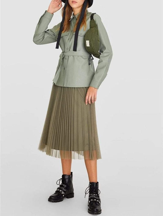 Woman wearing a green leather motorcycle shirt with a turn-down collar and black sashes. - HER SHOP