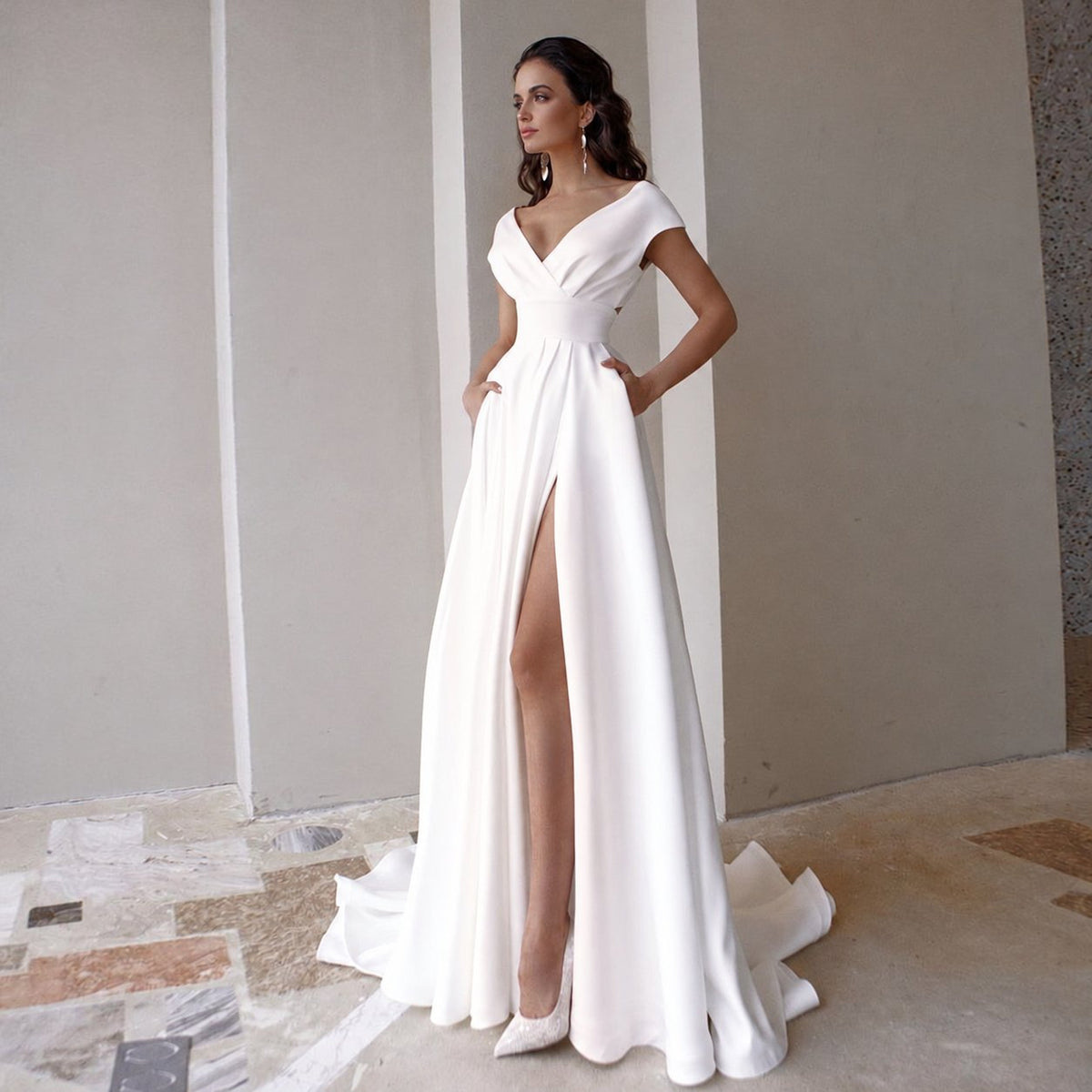 Front view of a white V-neck wedding dress with cap sleeves, pockets and a front slit - HER SHOP®